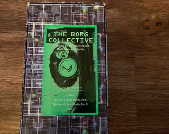 May include: A green and black box featuring a Star Trek: The Next Generation Borg Collective theme. The box includes four episodes: "Q Who!", "The Best Of Both Worlds, Part I", "The Best Of Both Worlds, Part II", and "I, Borg".