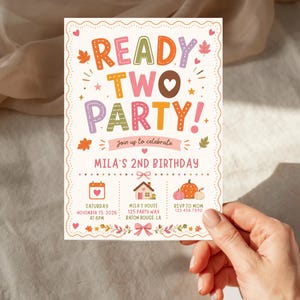 May include: A rectangular birthday invitation card featuring the text READY TWO PARTY! in colourful, stitched-style letters. The design includes autumn leaves, pumpkins, a house icon, and a calendar graphic with the date November 15, 2026, at 6 PM.