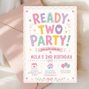 May include: A pastel-colored birthday invitation with the text "READY TWO PARTY!" and "MILA'S 2ND BIRTHDAY." The invitation includes event details: date, time, location, and RSVP information. The invitation is on a white background with a pink envelope.