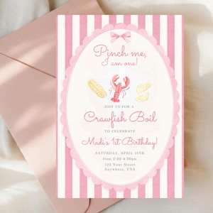 May include: A pink and white striped invitation card with the text "Pinch me, I am one!" and "Crawfish Boil" graphics. It includes event details for Madi's 1st birthday. The invitation is paired with a pink envelope.