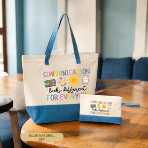 May include: A canvas tote bag and matching pouch set. The tote bag is off-white with a blue bottom and handles. The text "COMMUNICATION looks different FOR EVERYONE" is printed on the front, along with colorful graphics.