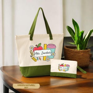May include: A canvas tote bag and matching pouch set. The bags are off-white with a green base and handles. The design features a red apple, coffee cup, pencil, and the text "Mrs. Sanders".