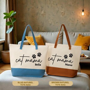Two tote bags with the text "cat mama Bella" printed on them, placed on a couch in a room with a plant and a lamp.