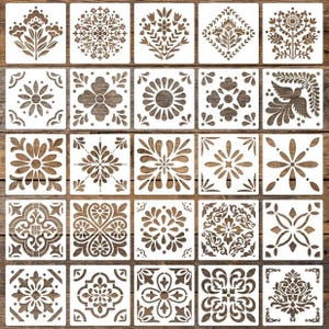 May include: A collection of twenty-five square white stencils featuring diverse floral, geometric, and avian patterns. Each stencil displays intricate cut-out designs including symmetrical blossoms, mandalas, leaves, and a bird motif for crafting.
