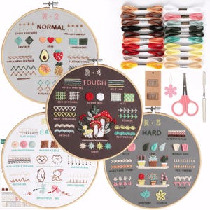 May include: Embroidery kit with four hoops showcasing various stitch techniques, labeled "Normal," "Tough," "Hard," and "Easy." Includes embroidery floss in multiple colors, needles, scissors, and a seam ripper. A comprehensive craft set for learning embroidery.