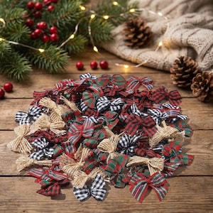 May include: A collection of small decorative bows in various patterns including red and green plaid, black and white gingham, and natural tan burlap. The bows are arranged in a cluster on a wooden surface, featuring fabric textures and tied knots.
