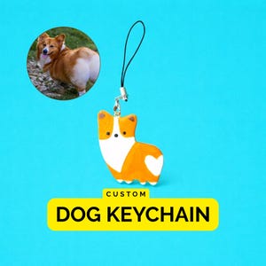 May include: A custom dog keychain featuring a flat, orange and white corgi-shaped charm with a black loop attachment. Above the charm is a circular photo of a corgi. Below the charm is a yellow rectangular label with the text CUSTOM DOG KEYCHAIN.