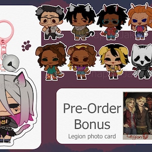 May include: A pink keychain with a cat-eared character charm, a silver bell, and several character stickers. The stickers feature various cartoon characters with animal ears. A "Pre-Order Bonus" Legion photo card is also included.