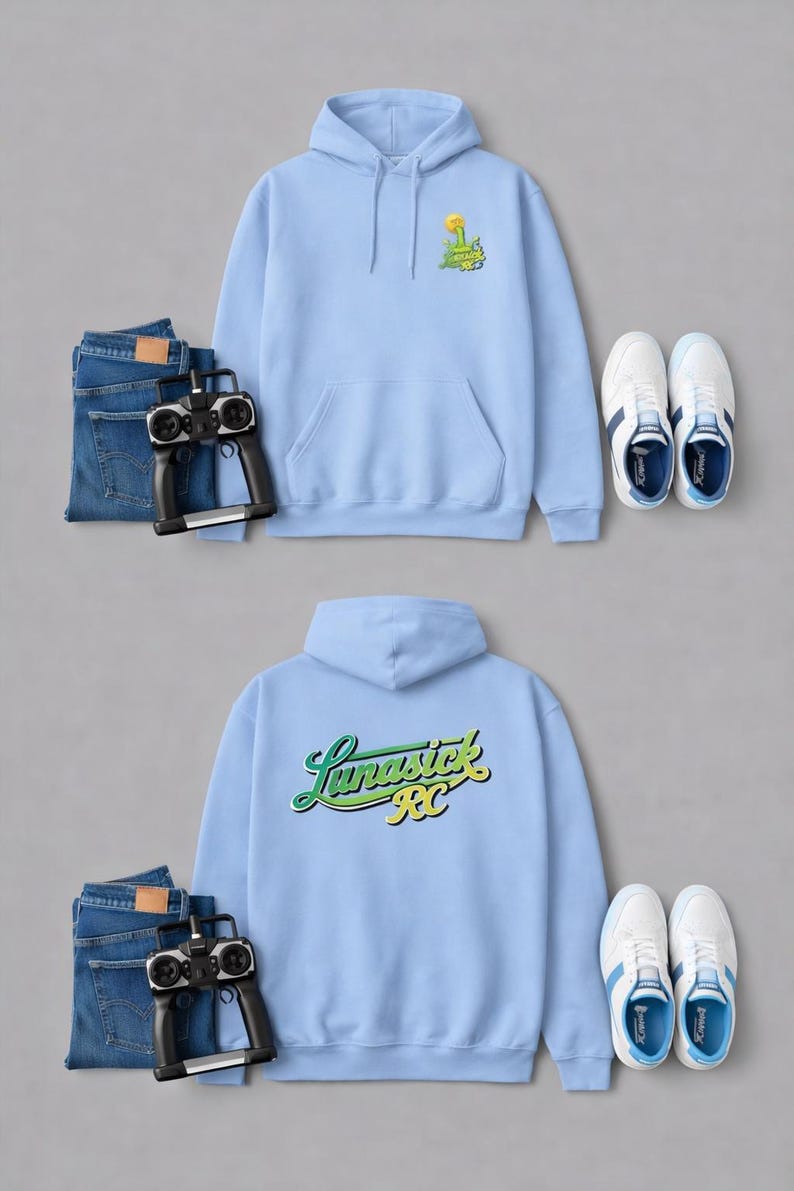 May include: Two light blue hoodies with the text "Lunastick RC" and a graphic on the front. The image also includes blue jeans, a remote control, and white sneakers with blue accents. The hoodies have a front pocket and a hood.