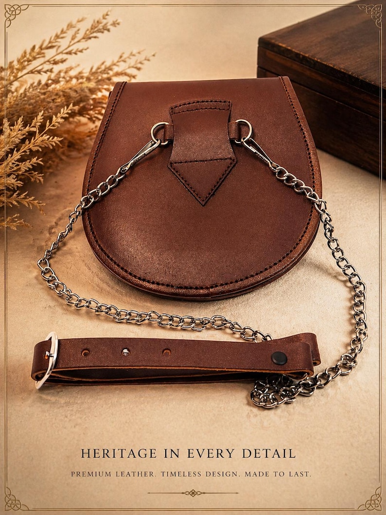 May include: A brown leather satchel with a silver chain strap and a separate leather belt. The satchel has a rounded shape and a flap closure. The text "HERITAGE IN EVERY DETAIL" is visible at the bottom of the image.