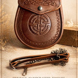 May include: A brown leather sporran with Celtic knotwork detailing and a decorative flap. The sporran features a central embossed design and a chain and leather strap. The text reads: HERITAGE. HANDCRAFTED. TIMELESS.