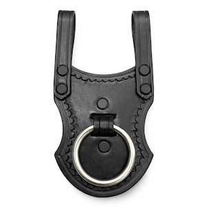 May include: Black leather belt loop with a decorative scalloped edge and a silver-colored metal ring. The loop has two vertical straps with black snap closures and is designed to attach to a belt. The item is shown against a white background.