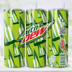 May include: A green and white tumbler with a straw, featuring the Mtn Dew logo in red, white, and green. The design includes a repeating pattern of green and white shapes. The tumbler also has a "please recycle" label and nutritional information.