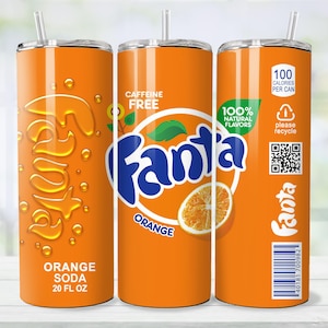 May include: Orange soda tumbler with a straw. The tumbler features the Fanta logo, orange slices, and the text "Orange Soda 20 FL OZ". The design includes "Caffeine Free" and "100% Natural Flavors".