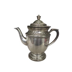 以下が含まれることがあります： 曲がった注ぎ口、ハンドル、蓋が付いた銀色のティーポット。 ティーポットは、本体とベースの周りに装飾的な花の模様があります。 蓋には小さなつまみが付いています。 ティーポットは、お茶を出すように設計されています。