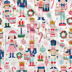 May include: A white fabric featuring a repeating pattern of watercolor-style nutcrackers in pink, blue, and red uniforms, interspersed with Christmas ornaments, candy canes, green wreaths, and gold stars on a clean white background.