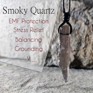 May include: Smoky Quartz pendant necklace with a black cord. The pendant is a translucent, rectangular crystal with a smoky brown hue. Text on the left reads "Smoky Quartz, EMF Protection, Stress Relief, Balancing, Grounding" and "AmorArt Jewelry".