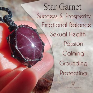 May include: A deep burgundy Star Garnet gemstone pendant, encased in a black woven net. The image includes text describing the stone's properties: Success & Prosperity, Emotional Balance, Sexual Health, Passion, Calming, Grounding, and Protecting.