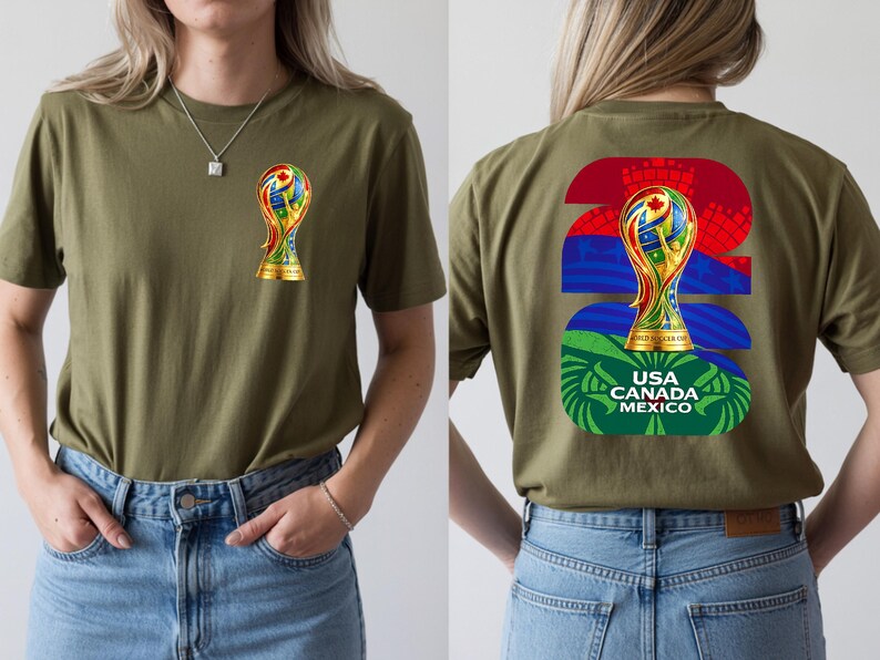 May include: Olive green t-shirt featuring a colorful trophy graphic on the front and back. The back design includes the number "22" in red and blue, the trophy, and the text "USA CANADA MEXICO".