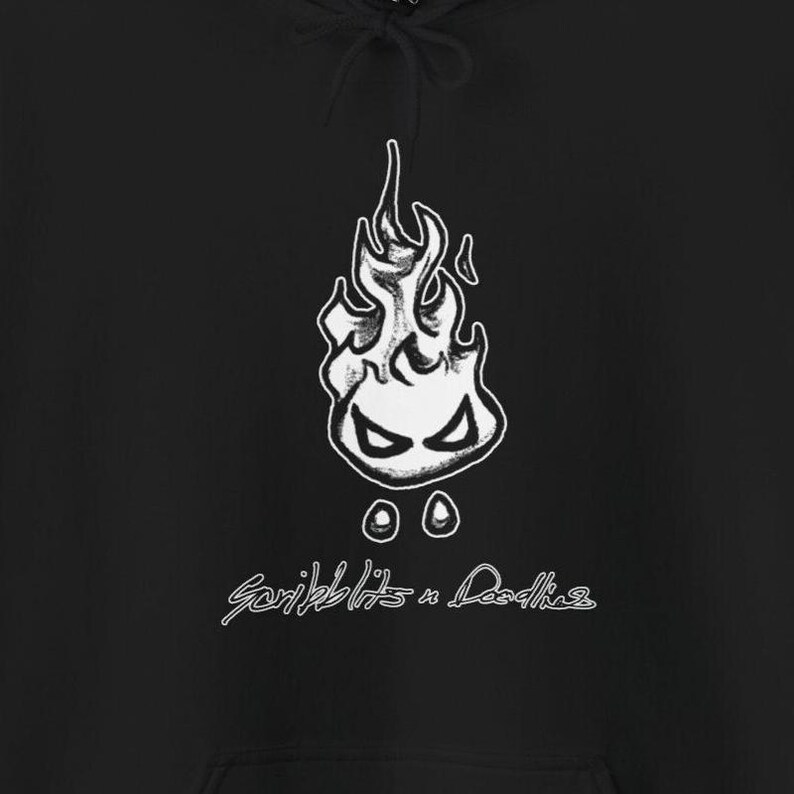 May include: Black hoodie with a white flame graphic, featuring a face, and the text "Scribblits n Doodles". The hoodie has a drawstring hood and a kangaroo pocket.