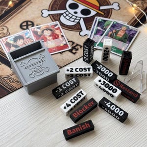 One Piece TCG Mega Set of 12 Tokens | Power, Cost, Keyword, and Constraint Modifiers | Jolly Roger Box Included | High-Quality 3D Printing