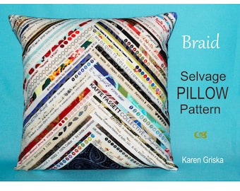 May include: Square pillow with a colorful patchwork design made from fabric selvages. The pillow features diagonal stripes of various fabric labels and text. The words "Braid," "Selvage Pillow Pattern," and the designer's name are visible.