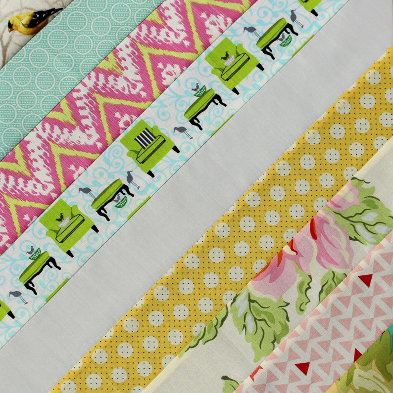 May include: A colorful patchwork design featuring various fabric patterns. Diagonal stripes showcase fabrics with pink chevrons, green armchairs, yellow polka dots, and floral prints. The design includes a white stripe and a bird-patterned fabric.