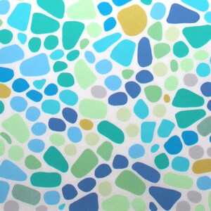 May include: Abstract pattern featuring a mosaic of irregular shapes and circles in shades of blue, green, yellow, and gray on a white background. The design is a repeating pattern of organic forms.