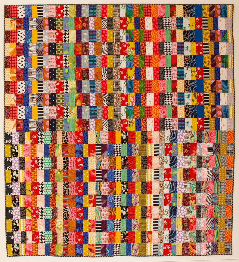 May include: A colorful patchwork quilt with a variety of patterns and colors, including red, yellow, blue, green, black, and white.