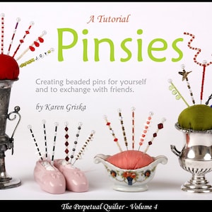 May include: A tutorial titled "Pinsies" with various beaded pins displayed in decorative holders. The pins feature colorful beads and are arranged in a red, green, and pink pin cushions. The text reads "Creating beaded pins for yourself and to exchange with friends."