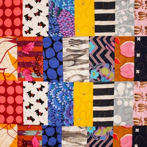 May include: A colorful patchwork quilt with various patterns, including polka dots, stripes, floral designs, and geometric shapes. The quilt is made up of different colored fabrics, including red, pink, blue, yellow, green, and brown.