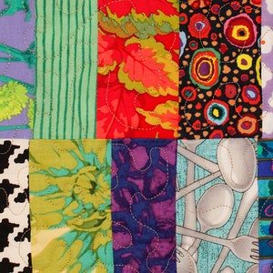 May include: A patchwork quilt with a variety of colorful fabrics and patterns. The quilt is made up of squares, each with a different design. Some of the patterns include flowers, geometric shapes, and abstract designs. The quilt is a vibrant and colorful piece of art.