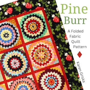 May include: A colorful quilt pattern called "Pine Burr" by Karen Griska. The quilt is made of fabric squares with a starburst design in the center. The fabric is a mix of red, pink, yellow, blue, green, and black.