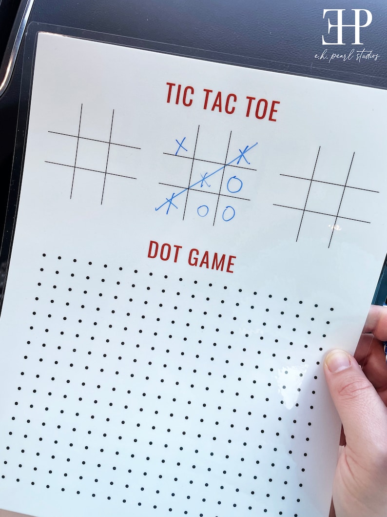 May include: A white sheet of paper with a black grid for a tic-tac-toe game. The game is partially played with blue X's and O's. Below the tic-tac-toe game is a black and white dot game.
