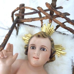 Antique religious statue infant child baby Jesus Christ nativity christmas handpainted figure w glass eyes and halo w twig crib for church
