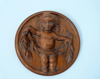 Antique wooden child or cherub putti bas relief panel medallion wall hanging decor French carved architectural salvaged architecture art