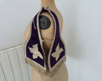 May include: A purple velvet collar with gold embroidered birds and fringe trim. The collar is displayed on a dress form.