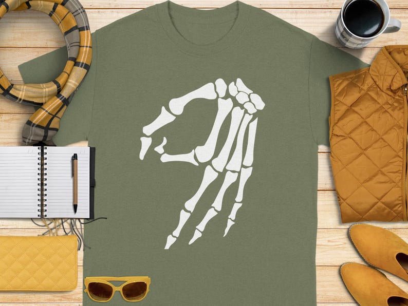 Olive green t-shirt with white "okay" hand gesture graphic.