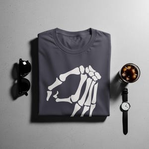 Dark gray t-shirt with white skeleton hand pointing gesture graphic.