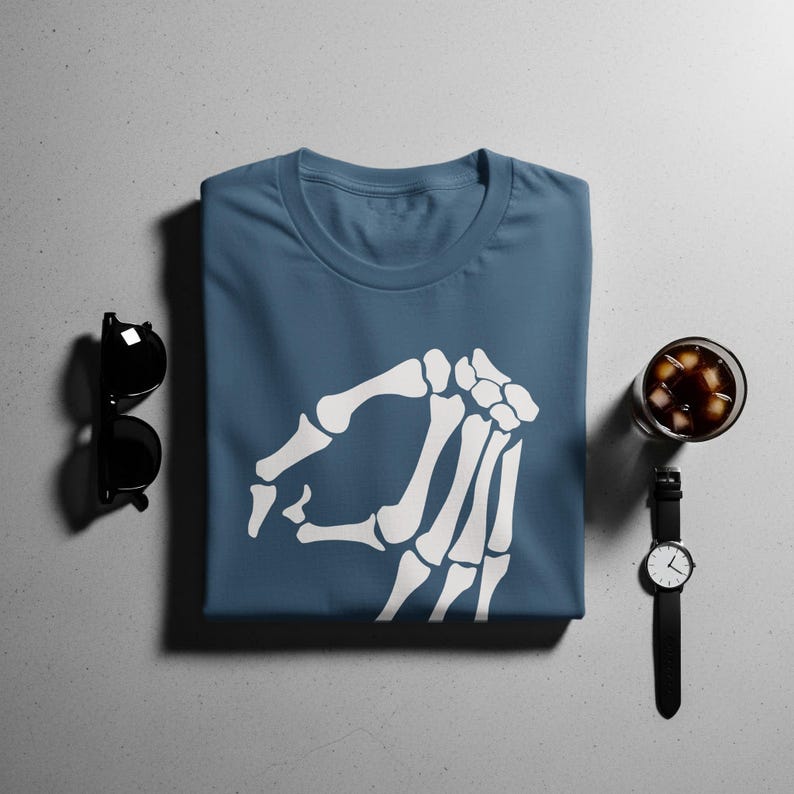 Blue t-shirt with white skeleton hand pointing left, sunglasses and watch.