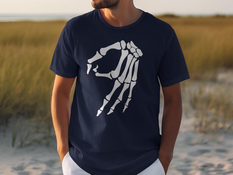 Navy t-shirt with white skeleton hand gesture graphic.