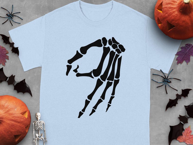 Light blue t-shirt with a black skeleton hand making the OK sign.