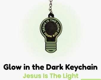 May include: A glow-in-the-dark keychain in the shape of a lightbulb. The keychain has the text "JESUS IS THE LIGHT" and "JOHN 8:12" in a circular design. The keychain is attached to a silver keyring.