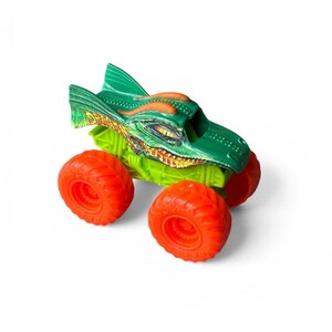 K&ouml;nnte beinhalten: Ein gr&uuml;nes und orangefarbenes Monstertruck-Spielzeug mit Drachendesign. Der Spielzeug-Truck hat gro&szlig;e orangefarbene R&auml;der, eine gr&uuml;ne Karosserie mit orangefarbenen Details und ein detailliertes Drachengesicht auf der Vorderseite.
