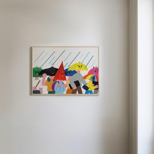 May include: A framed art print depicts a group of people walking in the rain. Each person has a colorful umbrella or hat, with blue rain streaks in the background. The artwork features a whimsical, cartoon-like style with bright colors.