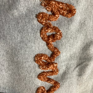 This is a Chenille script sweatshirt, with "horns" for a Texas Longhorn fan.