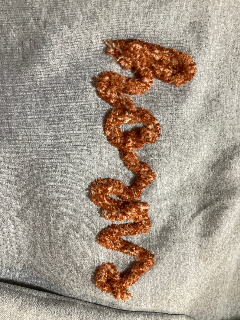 This is a Chenille script sweatshirt, with "horns" for a Texas Longhorn fan.