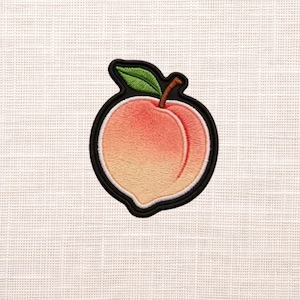 May include: Embroidered peach patch with a black border. The peach is a gradient of orange and pink, with a green leaf and brown stem. The patch is likely for clothing or accessories.