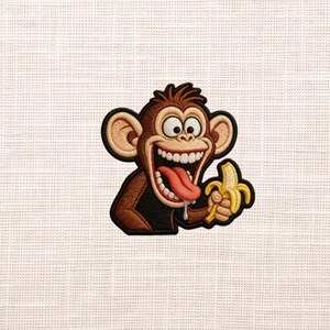 May include: Embroidered patch featuring a cartoon monkey with a wide, toothy grin, holding a banana. The monkey has brown fur, large ears, and a red tongue. The banana is yellow. The patch has a black border.
