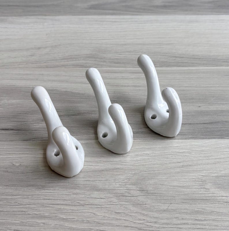 Vintage porcelain wall hooks in white
